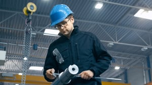 Factory worker is making a quality control of a metal _168980870-min
