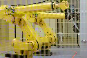 two yellow cnc machine tending robots for cnc automation
